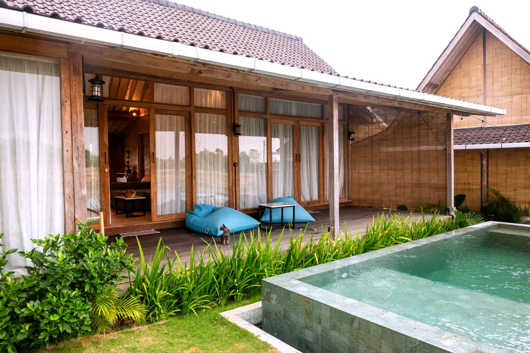Desa Kayu house exterior at dusk, with pool